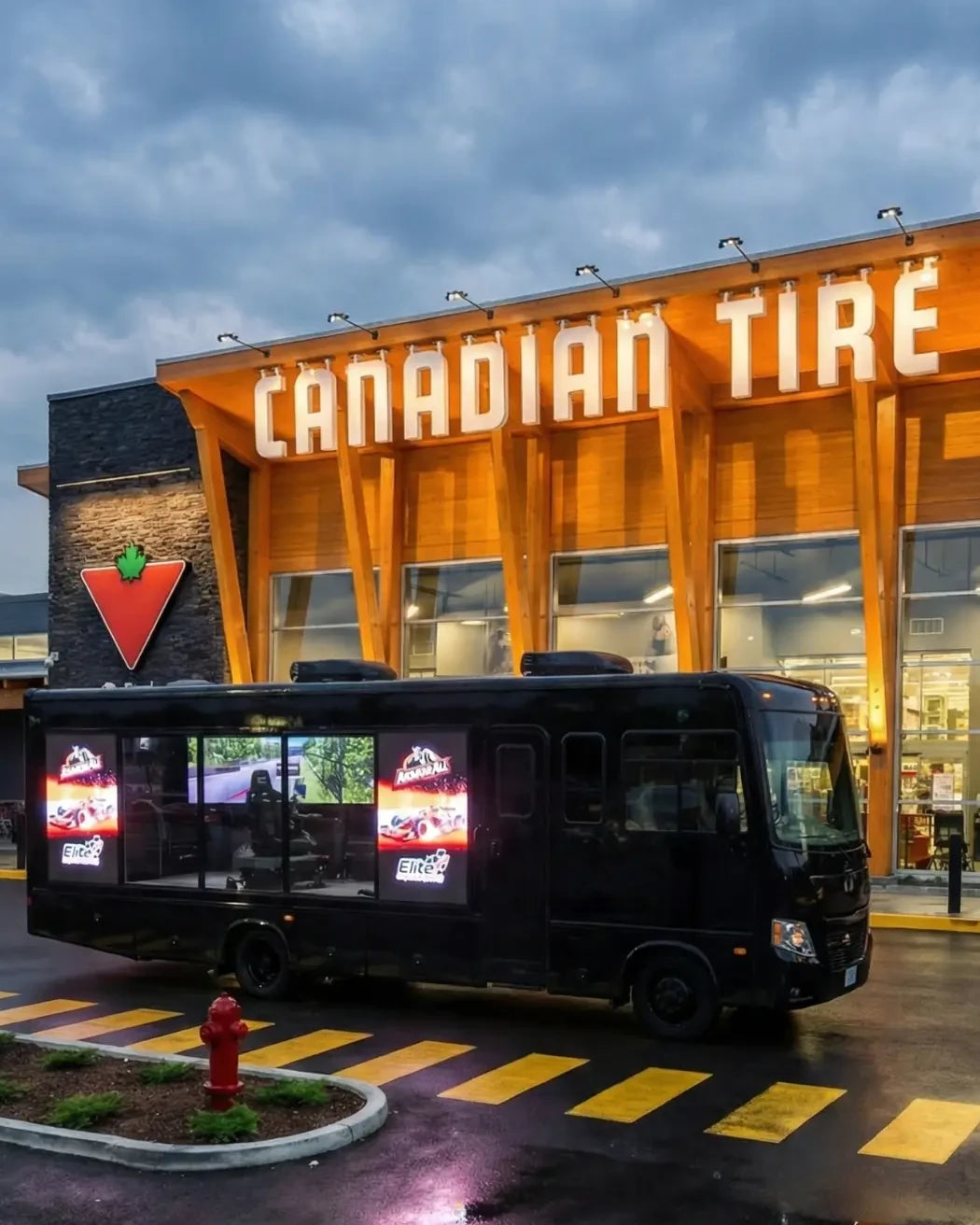 Simuluxor Mobile Race Studio motorhome at a Canadian Tire storefront with Armor All-branded racing simulators