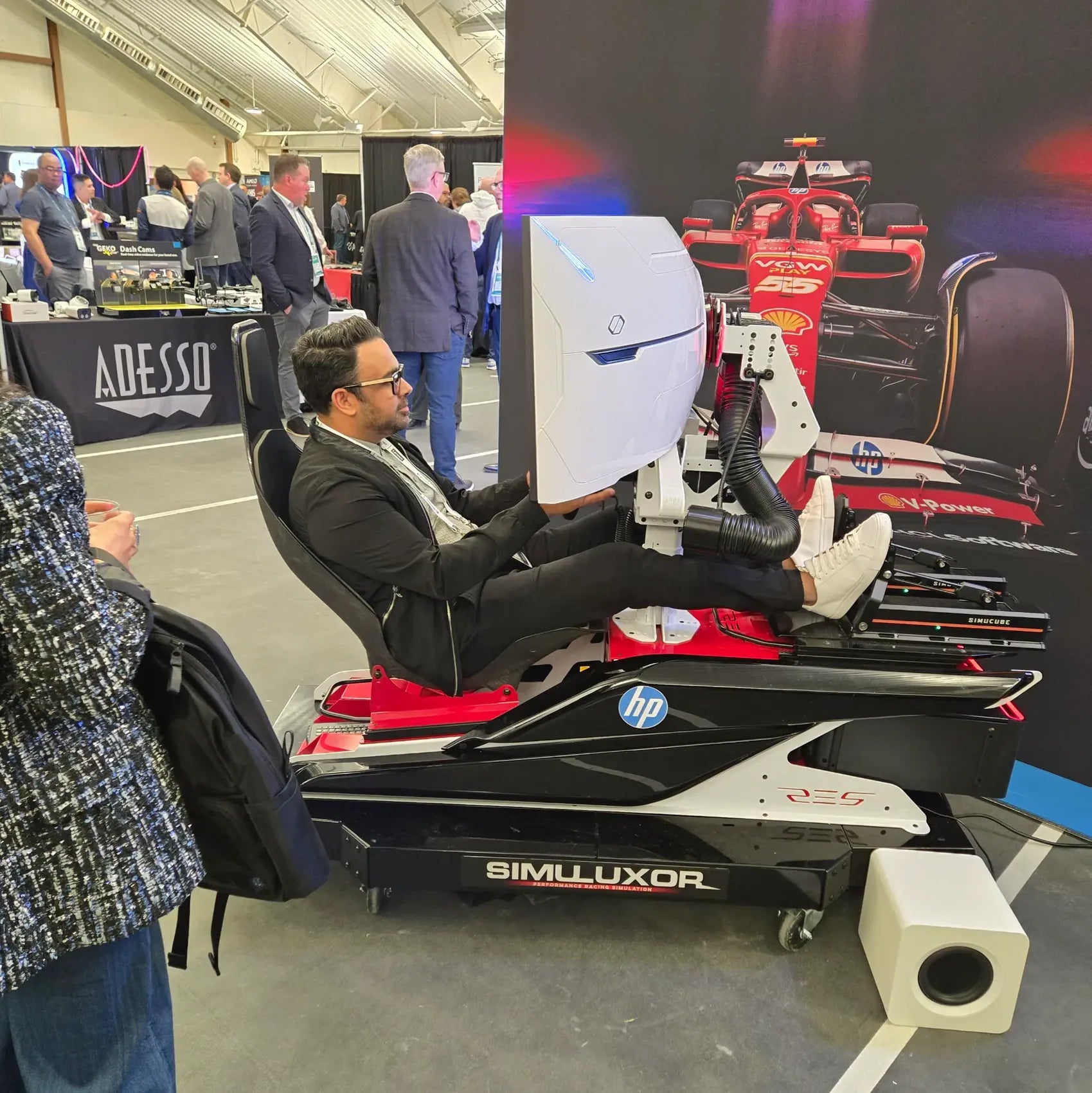 Guest racing in a Simuluxor professional simulator at an event
